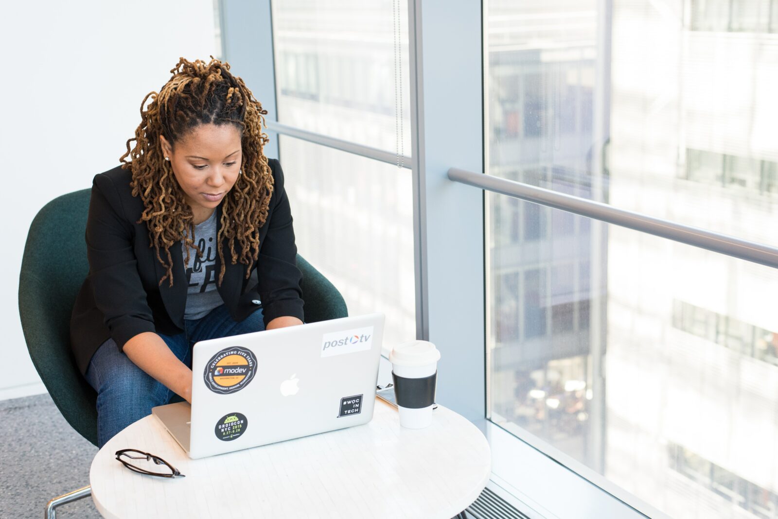 Person typing on a laptop in an office.